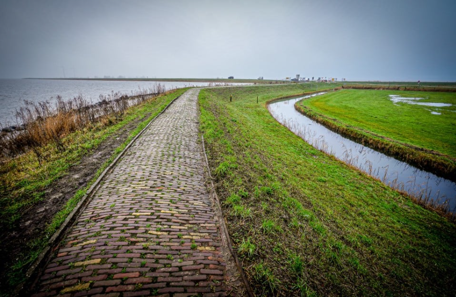 Marken doorstaat waterpiek met hulp van dijkwachten: beschadigde delen van omringdijk gemarkeerd met verf